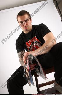 Alex Sitting With Pistol Pose 09